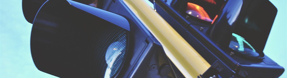 A traffic light against a blue sky.