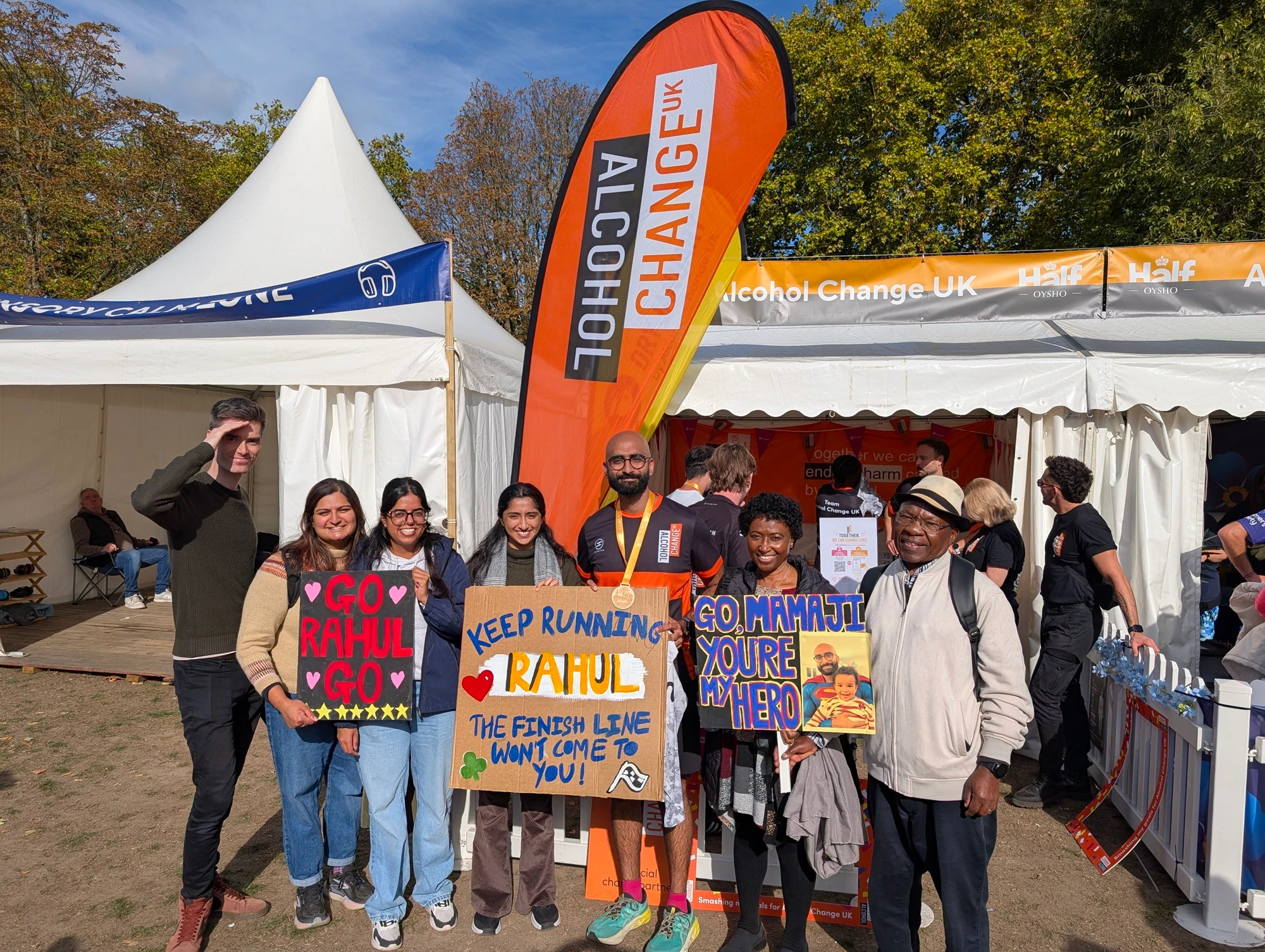 Supporters at the Royal Parks Half Marathon holding a sign spurring runner Rahul on