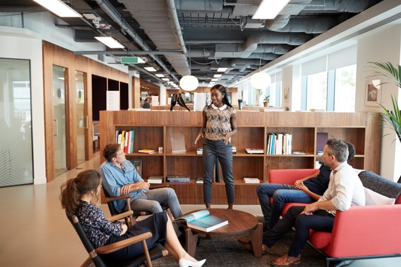 Casually dressed businessmen and businesswomen having informal meeting in a modern office.