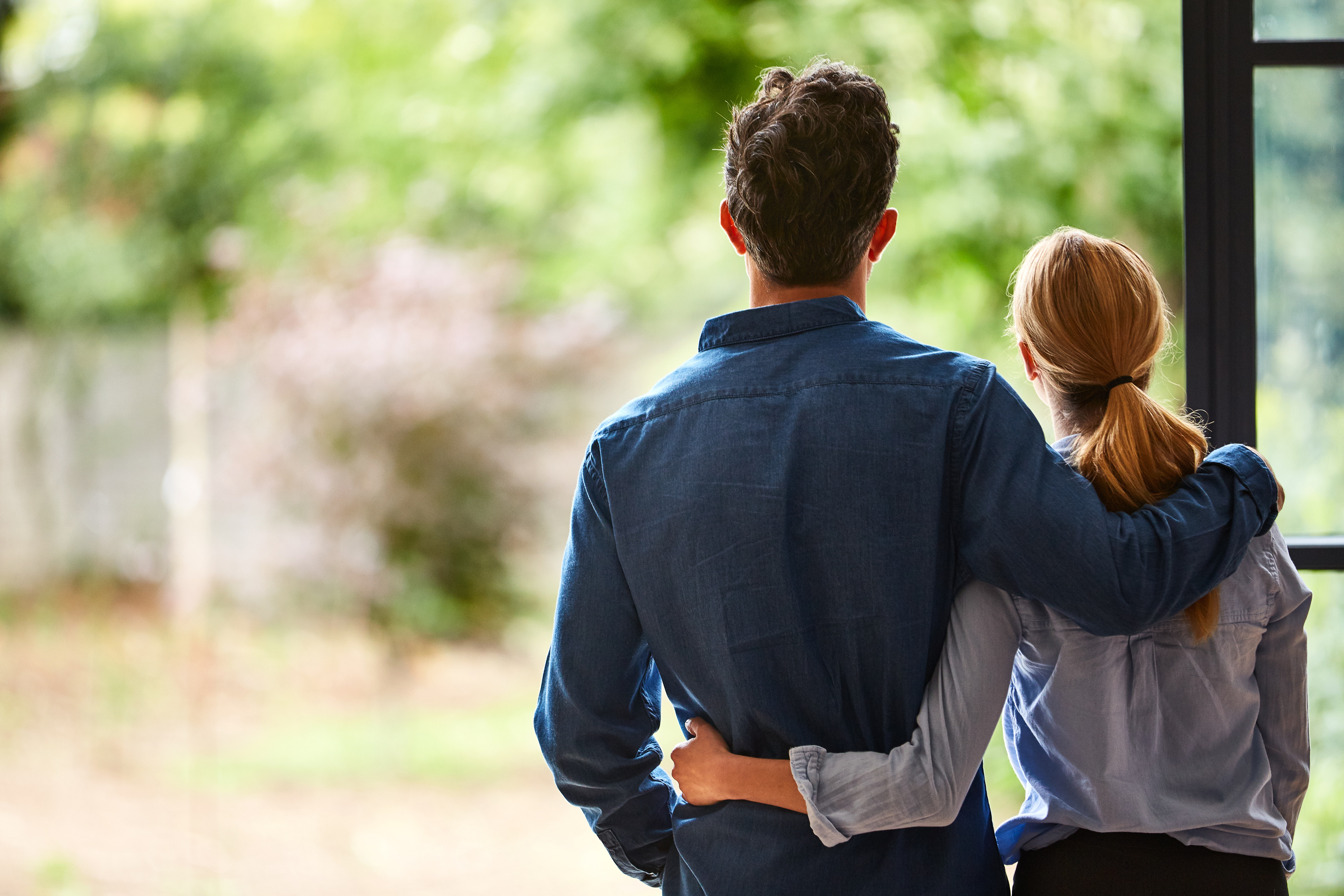 Couple in front of window