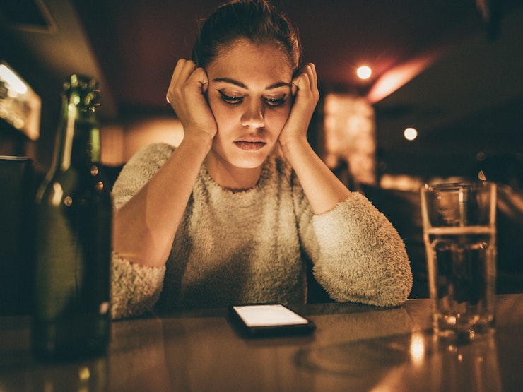 Depressed Woman Looking At Phone Message Istock 673833314