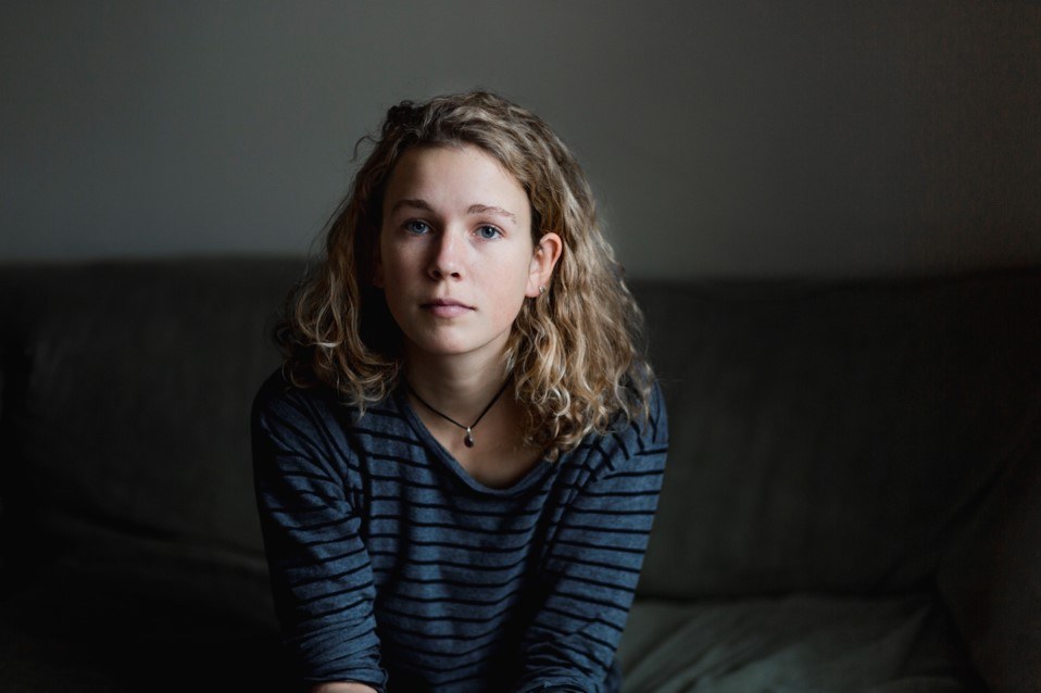 Girl sitting next to sofa