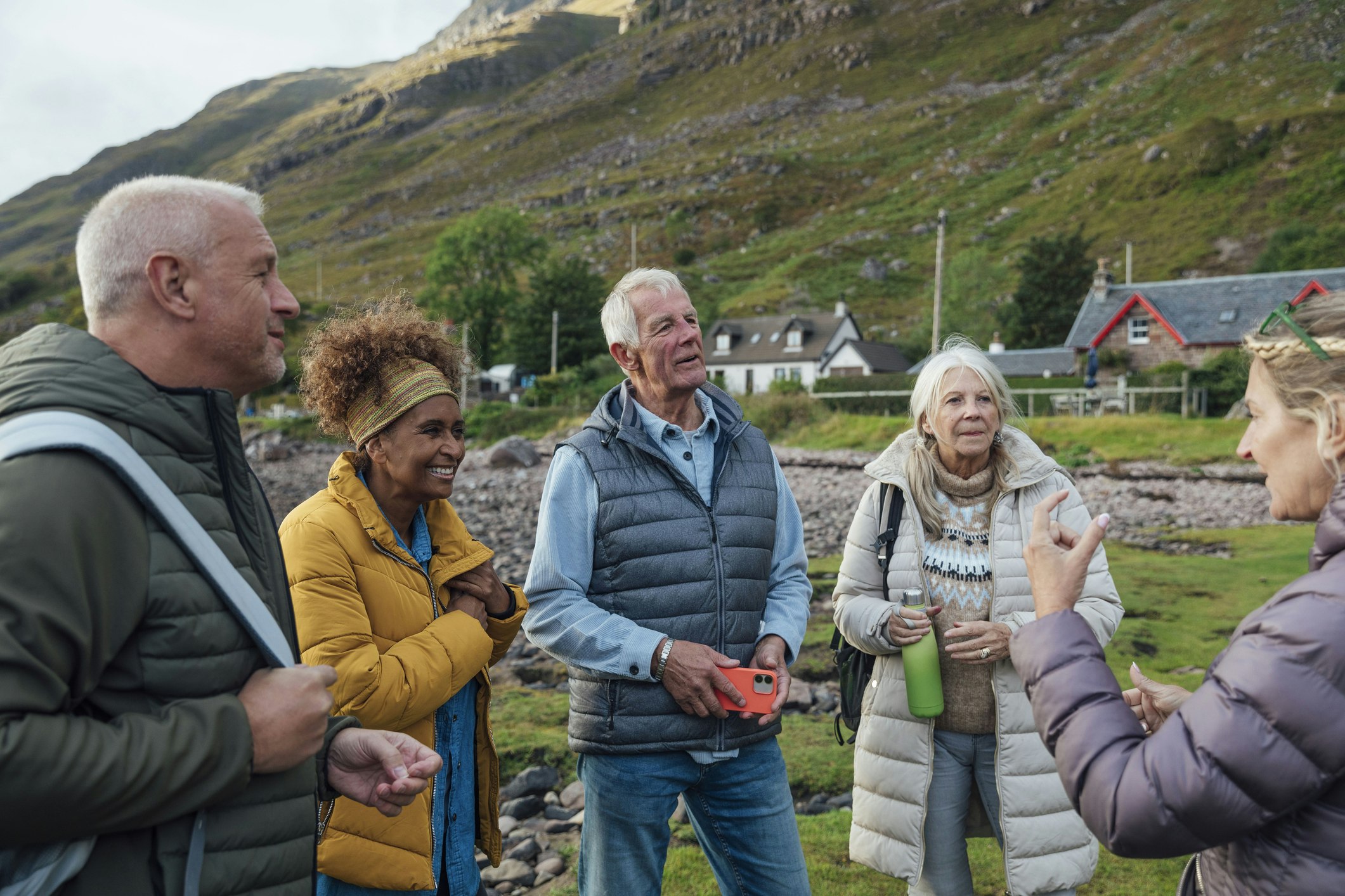 Group of people chatting beside the sea loch in Scotland