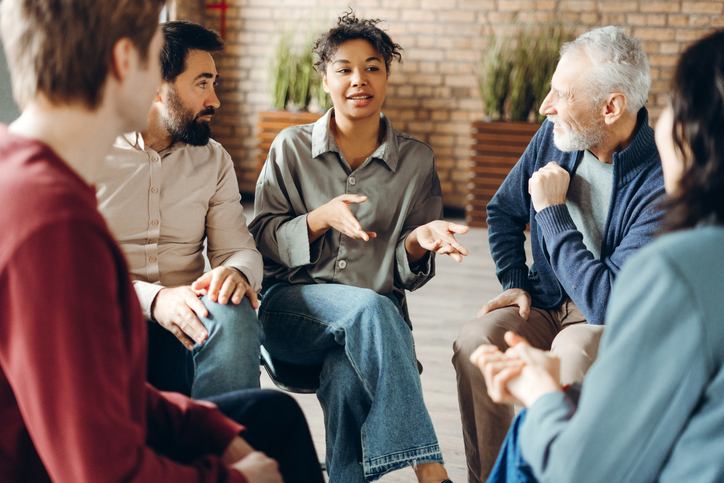 Group of people sitting in a circle small