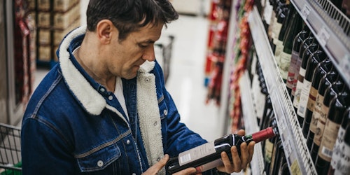 Man choosing wine in supermarket
