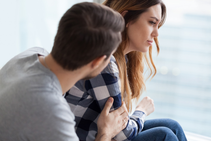 Man comforting young woman