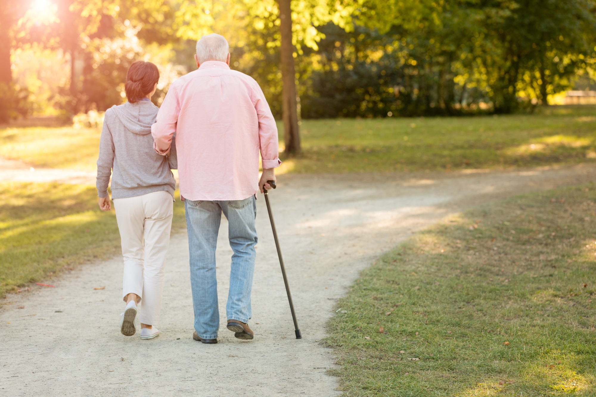 Man in care home outside with care worker