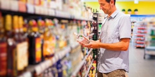Man In Supermarket In Alcohol Aisle Istock 530876175
