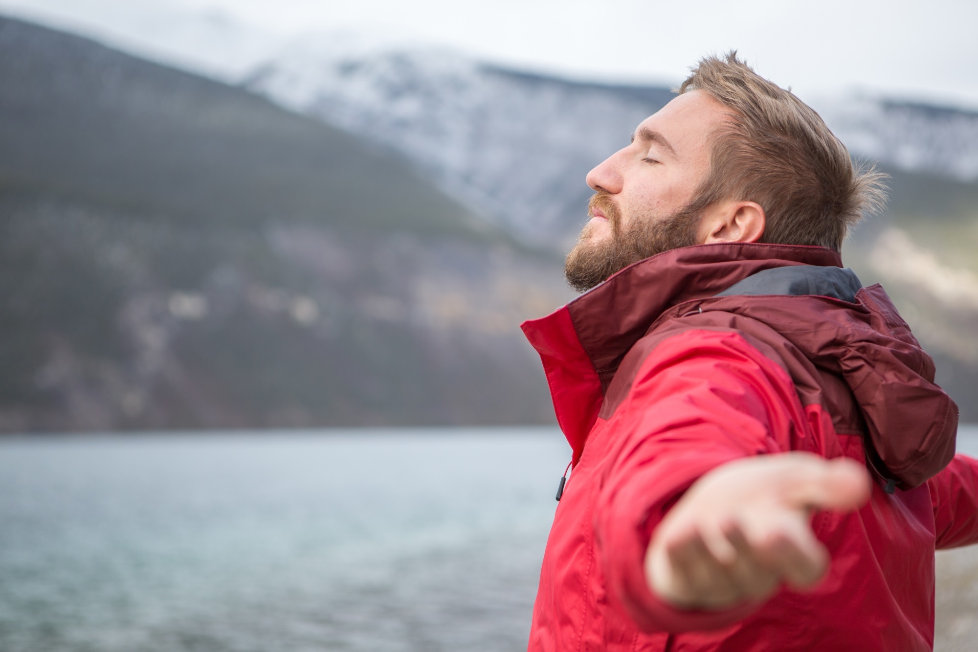 Man Outstretched By Lake Istock 500963564