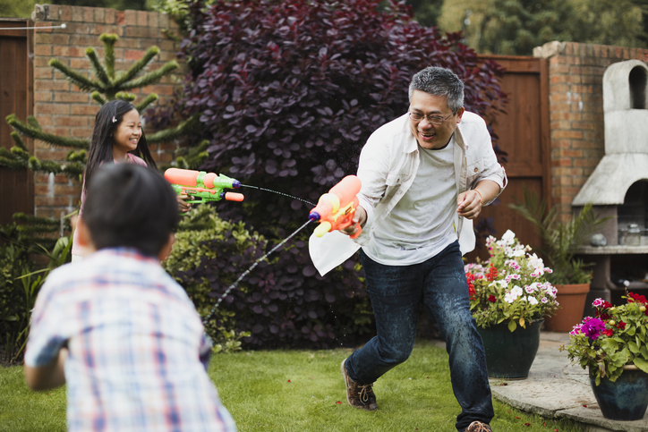 Man playing in garden with children