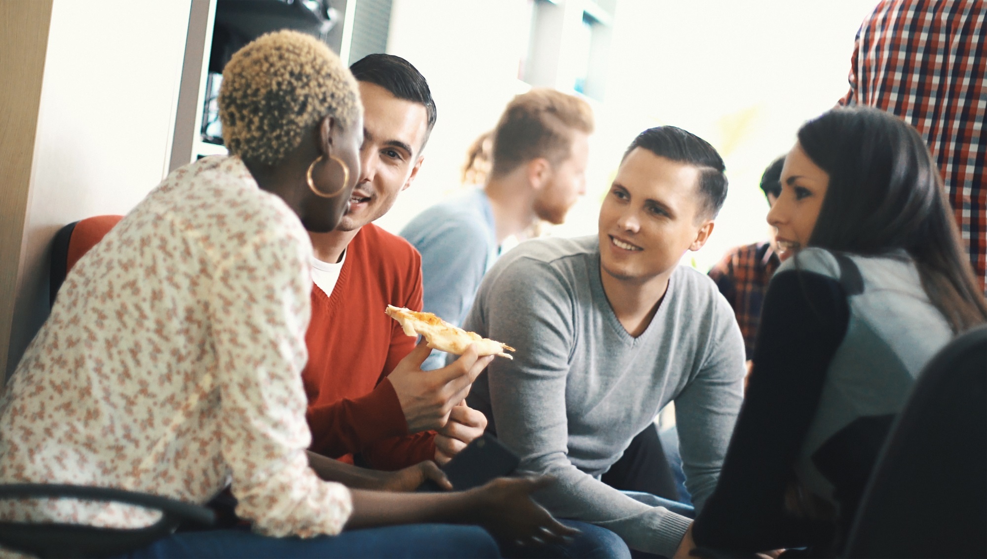 A group of people have food in a room.