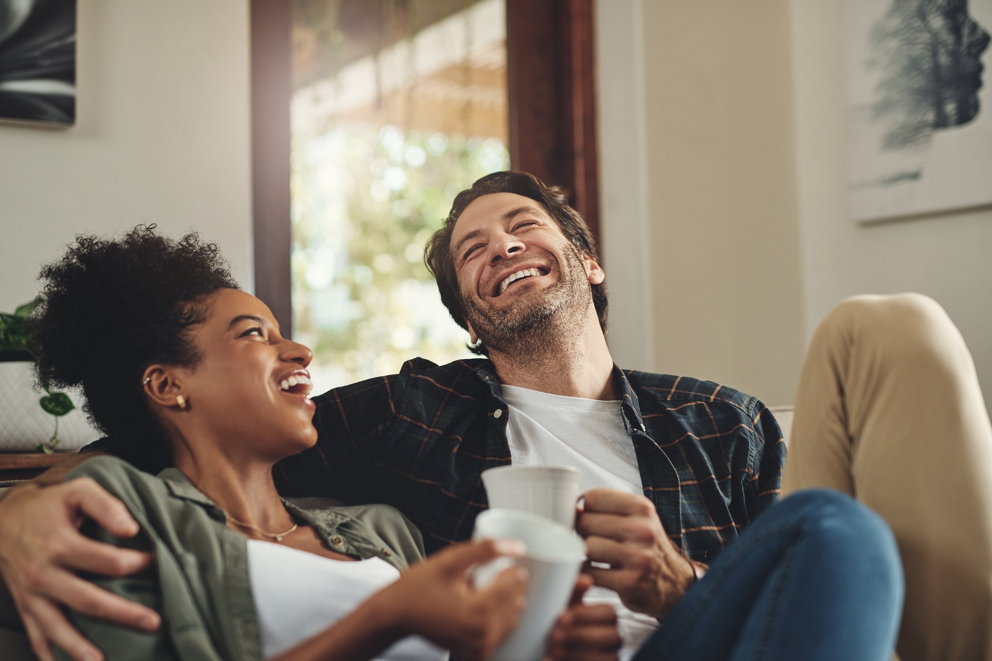 Shot of a happy young couple drinking coffee and spending some quality time together at home