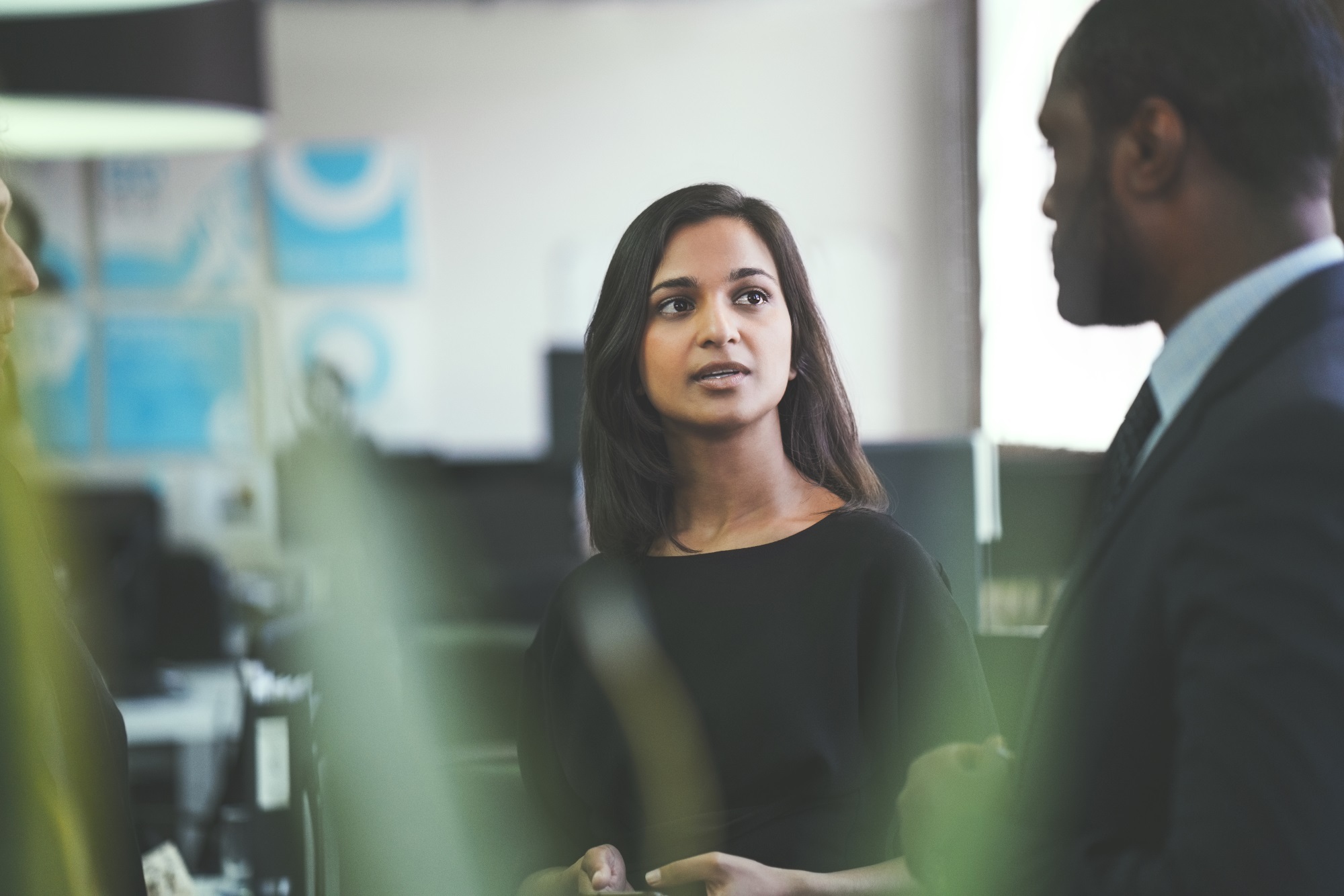 Smiling Businesswoman Discussing With Coworkers Istock 904457154