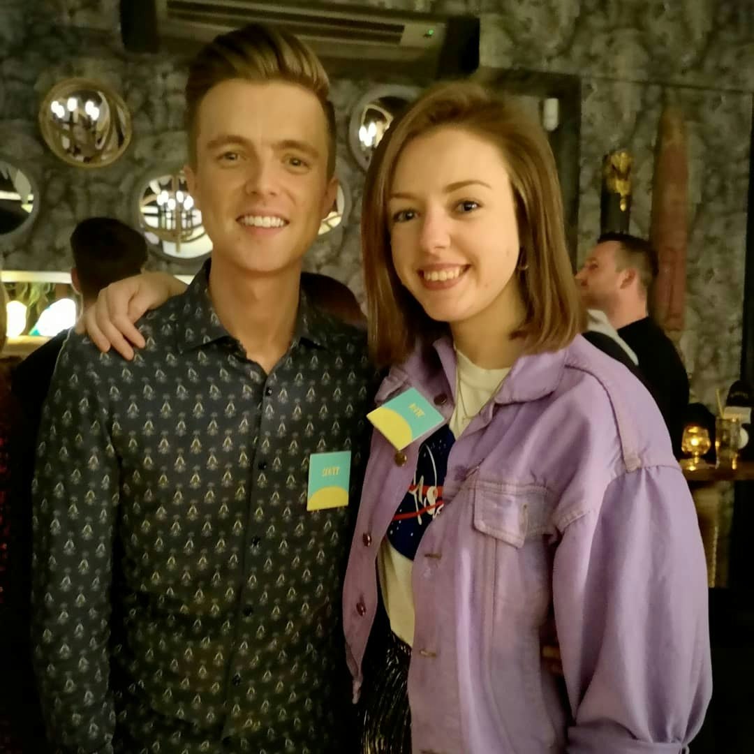 A young man and a young woman embrace.