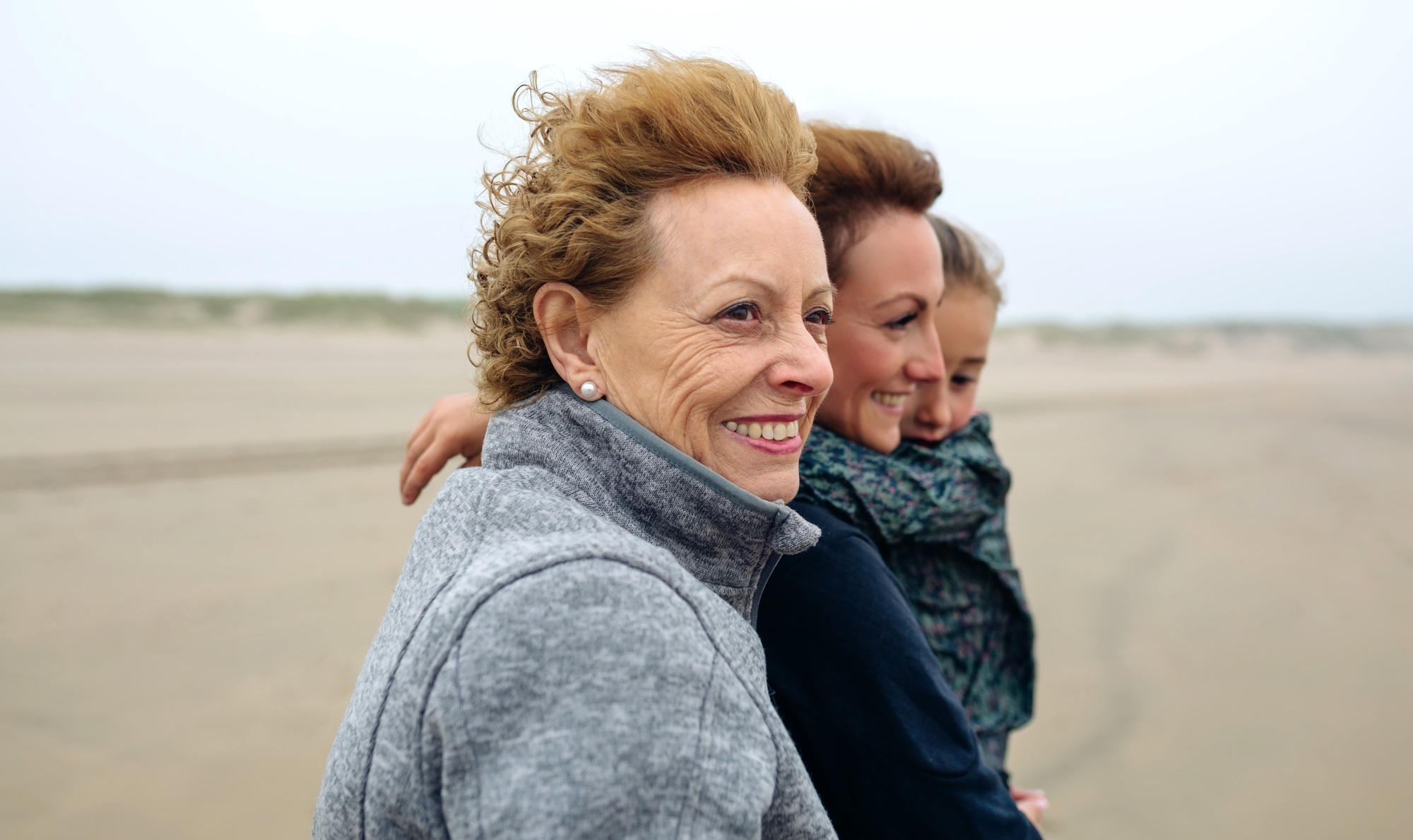 Three Generations Female Walking On Beach Istock 855081010