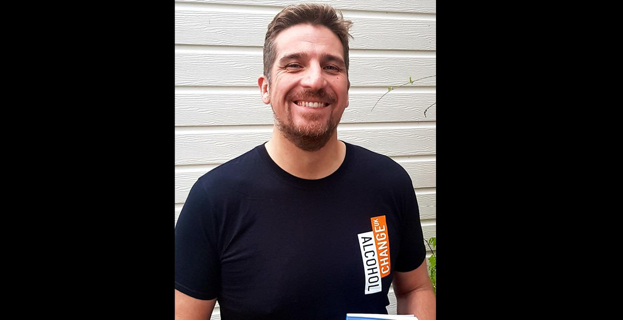 A man wearing a T-shirt which says: ALCOHOL CHANGE UK on it.