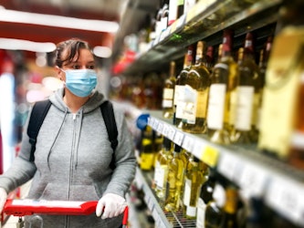 Woman buying wine with mask on