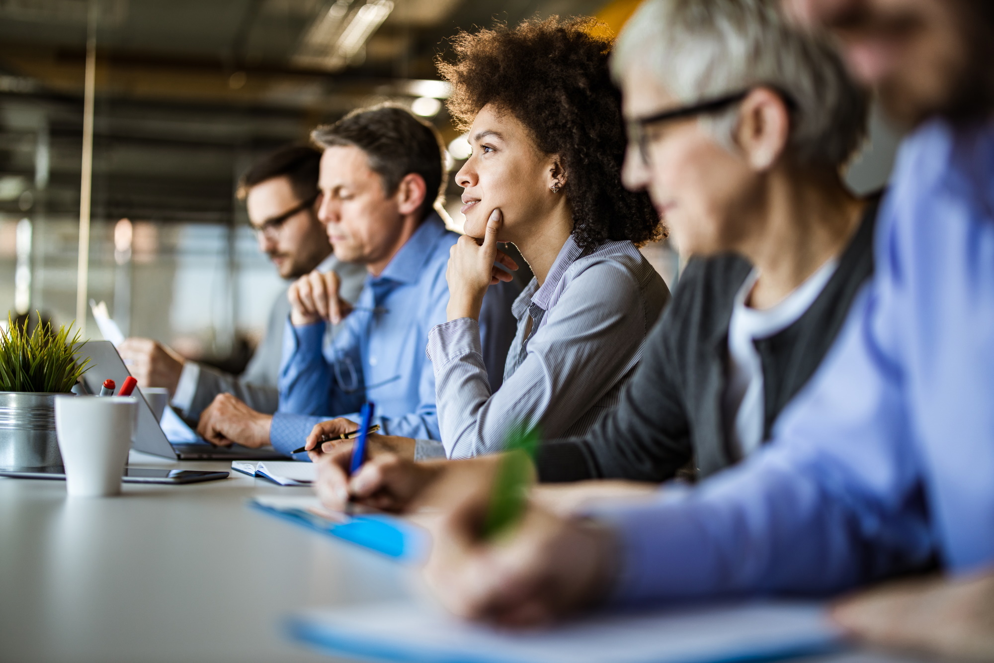 Woman thinking in business meeting