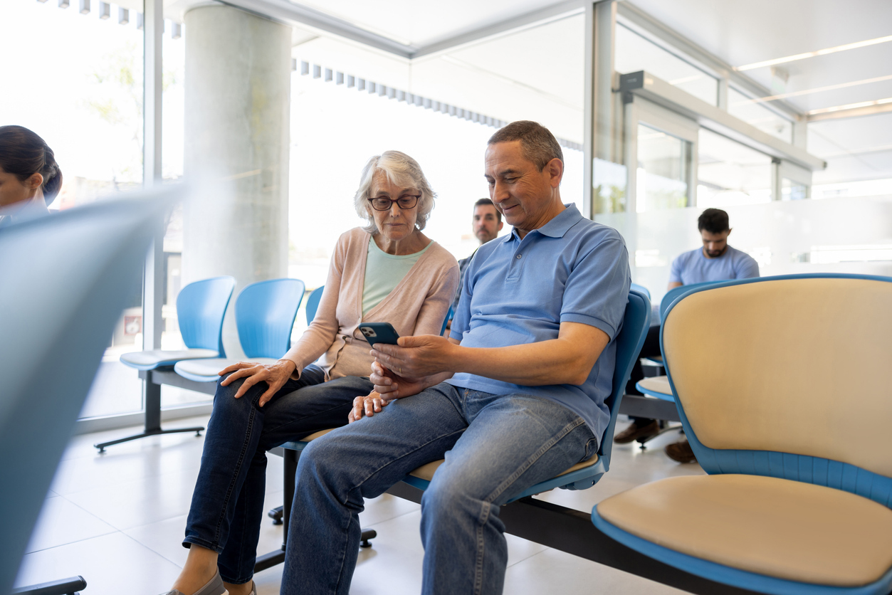 Senior woman with a companion in the waiting room at the hospital stock photo
